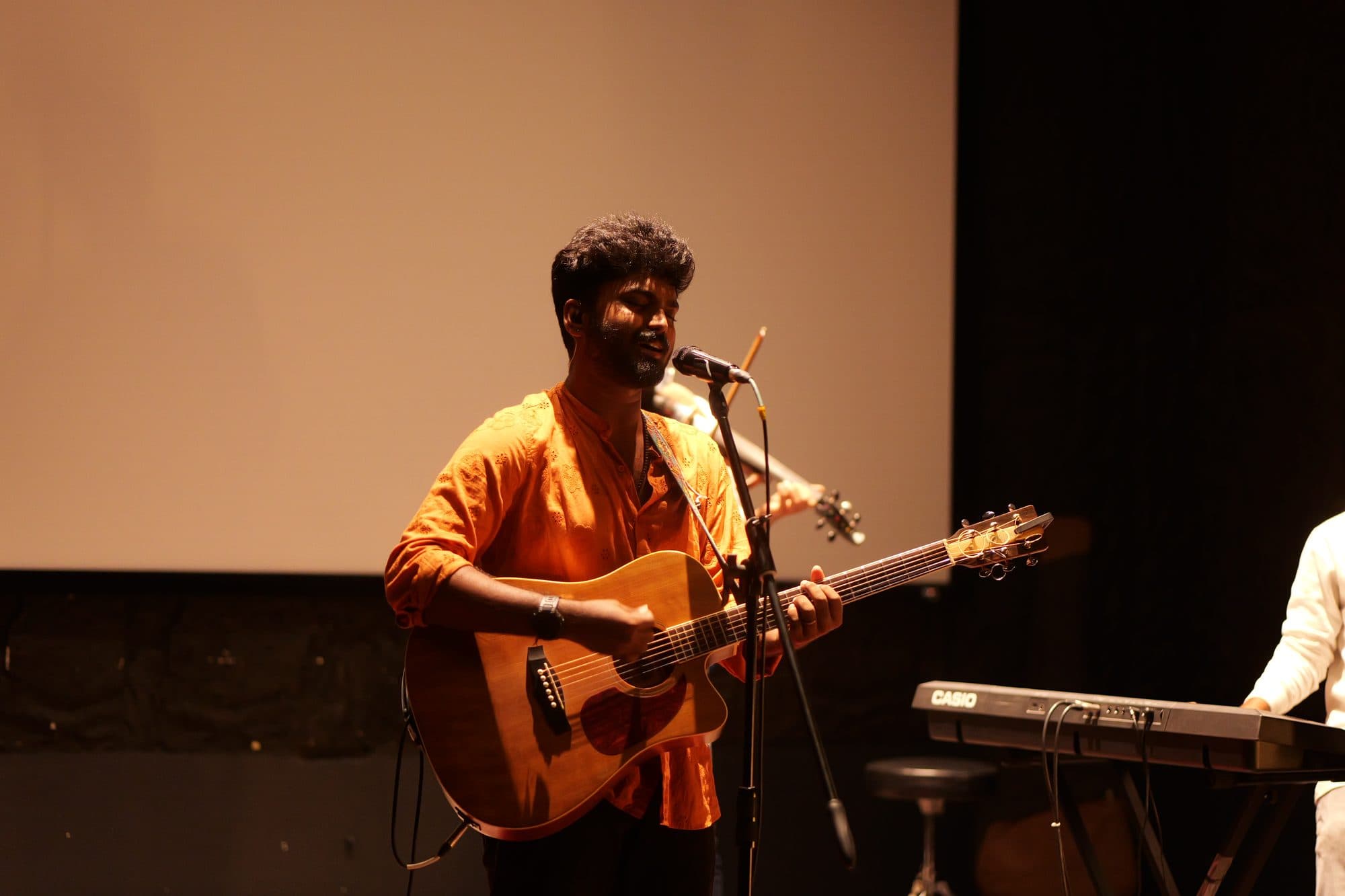 Ajay Nathan singing live with his guitar